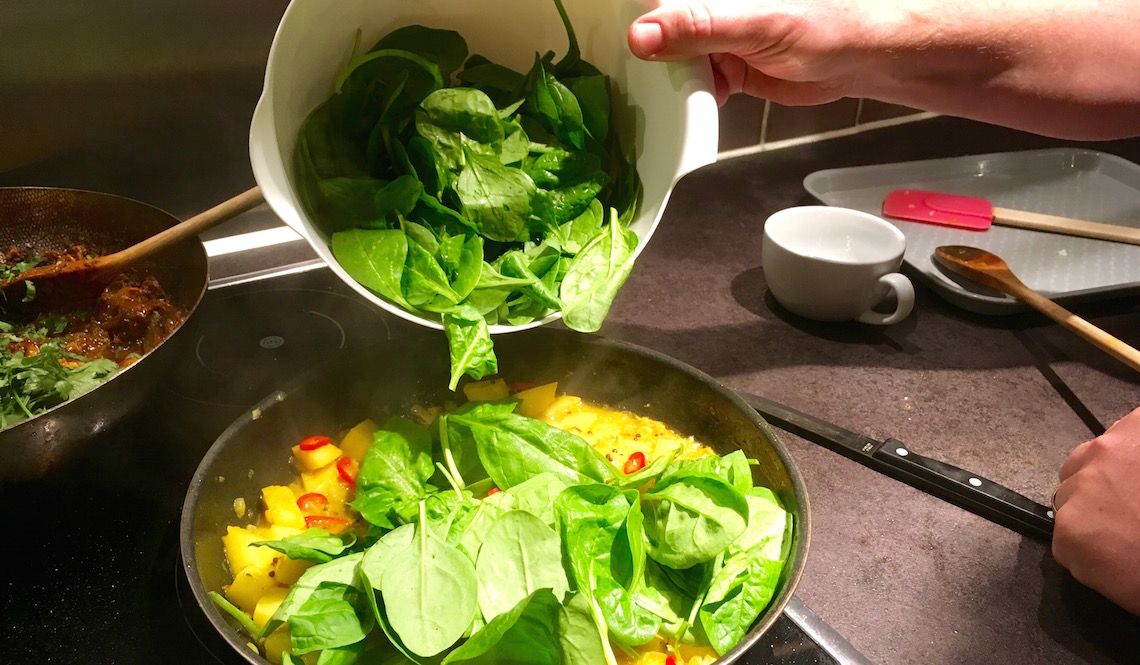 Making sag aloo on the Indian Cookery Course