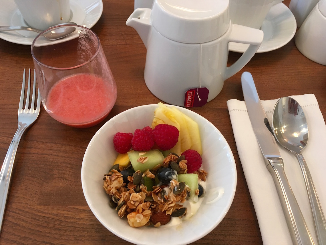 Breakfast starter of homemade granola and fruit smoothie