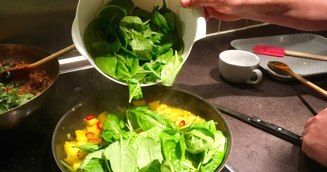 Making sag aloo on the Indian Cookery Course